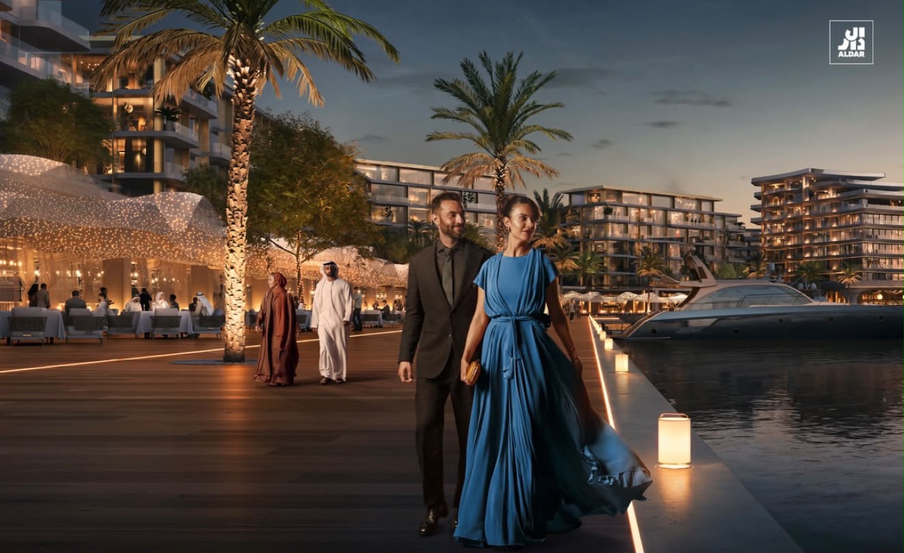 The marina promenade at Marsa Al Saadiyat in the evening, with a yacht moored alongside